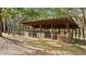 Covered wooden animal shelter with multiple stalls at 4540 Oakfield Cir, Dade City, FL 33523