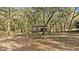 Rustic wooden animal shelter in a wooded setting at 4540 Oakfield Cir, Dade City, FL 33523