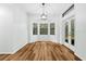 Bright dining area with wood flooring and French doors to backyard at 4540 Oakfield Cir, Dade City, FL 33523