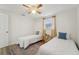 Bedroom with two twin beds, ceiling fan, and wood-look flooring at 4549 Madison St, New Port Richey, FL 34652