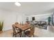 Bright dining area with wood table and four chairs, adjacent to living room at 4549 Madison St, New Port Richey, FL 34652