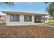 White house exterior with screened porch and partial view of yard at 4549 Madison St, New Port Richey, FL 34652