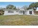 Newly renovated white house exterior with a gray garage door at 4549 Madison St, New Port Richey, FL 34652