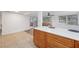 Kitchen island with white quartz countertop and wood cabinets at 4549 Madison St, New Port Richey, FL 34652