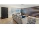 Living room with gray sofa and a stylish wood accent wall at 4549 Madison St, New Port Richey, FL 34652