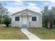 Tan house with white trim, front porch, and small yard at 4562 3Rd S Ave, St Petersburg, FL 33711