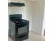 Black gas range and range hood with white cabinets at 4562 3Rd S Ave, St Petersburg, FL 33711