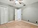 Simple bedroom with tile floors and white louvered doors at 4920 Steel Dust Ln, Lutz, FL 33559