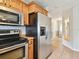 Kitchen with stainless steel appliances and wood cabinets at 4920 Steel Dust Ln, Lutz, FL 33559