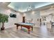 Bright game room with a pool table, modern chandelier, and views of adjacent kitchen and sitting area at 5000 Culbreath Key Way # 2-202, Tampa, FL 33611