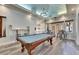 Stylish game room featuring a pool table, overhead chandelier and seating area, and access to outdoor dining at 5000 Culbreath Key Way # 2-202, Tampa, FL 33611