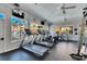 Well-equipped gym with treadmills, exercise bikes, ceiling fans, and scenic views through large windows at 5000 Culbreath Key Way # 2-202, Tampa, FL 33611