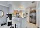 Well-lit kitchen featuring a breakfast bar and stainless steel appliances at 5000 Culbreath Key Way # 2-202, Tampa, FL 33611