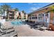 Tranquil community pool area with comfortable lounge chairs and multi-story condominiums in background at 5000 Culbreath Key Way # 2-202, Tampa, FL 33611