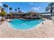 Expansive community pool area with a clubhouse, palm trees, lounge chairs, and a sun-soaked deck at 5000 Culbreath Key Way # 2-202, Tampa, FL 33611