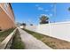 Scenic walking path with a white fence, offering a peaceful outdoor experience alongside well-maintained landscaping at 5000 Culbreath Key Way # 2-202, Tampa, FL 33611