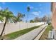 Inviting walking path alongside a white fence, perfect for a leisurely stroll with lush trees and blue skies overhead at 5000 Culbreath Key Way # 2-202, Tampa, FL 33611