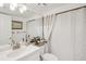 Clean bathroom with a white vanity and polka-dot shower curtain at 5117 Lesher Ct, Tampa, FL 33624