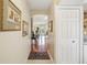 Light and airy hallway with hardwood floors and access to living areas at 5117 Lesher Ct, Tampa, FL 33624