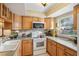 Galley-style kitchen with wood cabinets and a window at 5117 Lesher Ct, Tampa, FL 33624