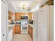 Well-equipped kitchen featuring wood cabinets and modern appliances at 5117 Lesher Ct, Tampa, FL 33624