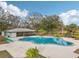 Community pool with a covered patio and lounge chairs at 5117 Lesher Ct, Tampa, FL 33624