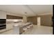 Modern kitchen with white cabinets, marble island and integrated appliances at 5120 Marina Way # 31101, Tampa, FL 33611