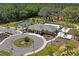 Aerial view of a community clubhouse with a pool and tennis courts at 5149 Jennings Trl, Brooksville, FL 34601