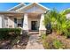 Front porch with brick walkway, palm trees, and rocking chair at 5149 Jennings Trl, Brooksville, FL 34601