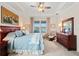 Main bedroom with dresser, large bed, and lake view at 5149 Jennings Trl, Brooksville, FL 34601