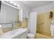 Bathroom with shower/tub combo, white vanity, and yellow tile at 5267 81St N St # 12, St Petersburg, FL 33709