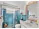 Bathroom with a walk-in shower, white vanity, and blue tile at 5267 81St N St # 12, St Petersburg, FL 33709