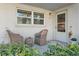 Cozy front porch with wicker chairs and a small table at 5267 81St N St # 12, St Petersburg, FL 33709