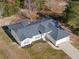 Aerial view of a single-story house with a gray roof and attached garage at 6119 Freeport Dr, Spring Hill, FL 34606