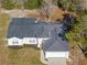 Single-story house with gray roof, attached garage, and landscaped yard, viewed from above at 6119 Freeport Dr, Spring Hill, FL 34606