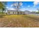 Large backyard with grassy area and home view at 6119 Freeport Dr, Spring Hill, FL 34606