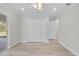 Bright bedroom with wood-look floors, ceiling fan, and sliding door access to the outdoors at 6119 Freeport Dr, Spring Hill, FL 34606