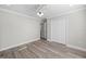 Well-lit bedroom with wood-look floors and a large closet at 6119 Freeport Dr, Spring Hill, FL 34606