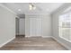 Bright bedroom with wood-look floors, double door closet and ceiling fan at 6119 Freeport Dr, Spring Hill, FL 34606