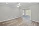 Light and airy bedroom featuring wood-look floors and sliding glass doors at 6119 Freeport Dr, Spring Hill, FL 34606