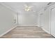 Well-lit bedroom with ceiling fan and wood-look flooring at 6119 Freeport Dr, Spring Hill, FL 34606