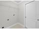 Bright laundry room with built-in shelving and tile flooring at 6119 Freeport Dr, Spring Hill, FL 34606