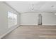 Bright and airy living room with wood-look flooring and plenty of natural light at 6119 Freeport Dr, Spring Hill, FL 34606