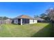 Spacious backyard with screened patio and grassy area at 6932 Oakcrest Way, Zephyrhills, FL 33542