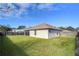 Backyard view showing home exterior and fence at 6932 Oakcrest Way, Zephyrhills, FL 33542