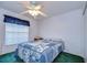 Guest bedroom with ceiling fan and window coverings at 6932 Oakcrest Way, Zephyrhills, FL 33542