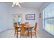 Bright dining area with wood table and chairs near sliding glass doors at 6932 Oakcrest Way, Zephyrhills, FL 33542