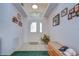 Bright entryway with tiled floors, storage bench and high ceilings at 6932 Oakcrest Way, Zephyrhills, FL 33542