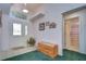 Home entryway featuring a tiled floor, bench, and bathroom door at 6932 Oakcrest Way, Zephyrhills, FL 33542