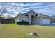 One-story house with attached garage and landscaping at 6932 Oakcrest Way, Zephyrhills, FL 33542